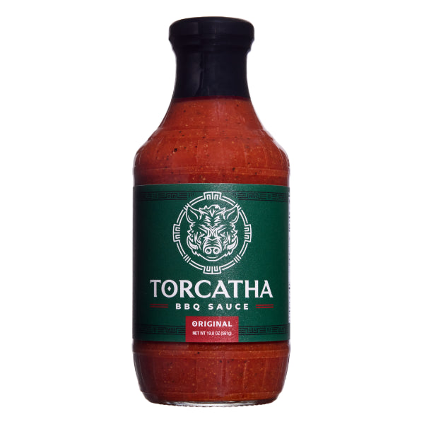 Bottle of Original Torcatha BBQ Sauce with a green battle  boar on the label, an image the Torcatha brand is known for, on a white background.
