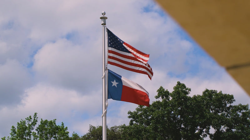 Montage of video images featuring the American and Texan flags, barbecue sauce being stirred, Torcatha BBQ Sauce bottles on a production line, a fire truck pulling out of a station, and close-ups of the Battle Boar logo that represents the Torcatha brand.